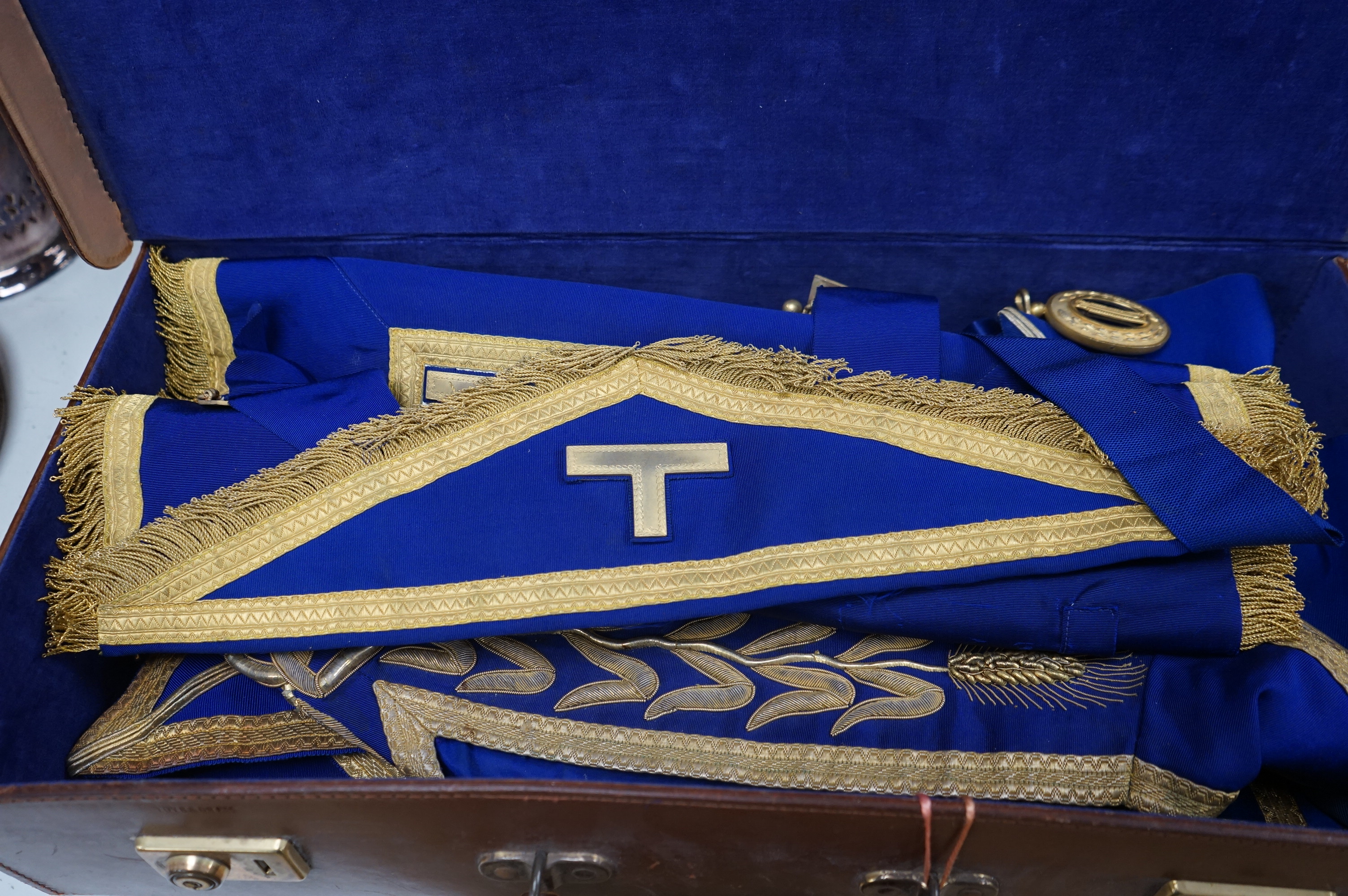 A suitcase containing Masonic related items including apron, sash etc. Condition - fair to good